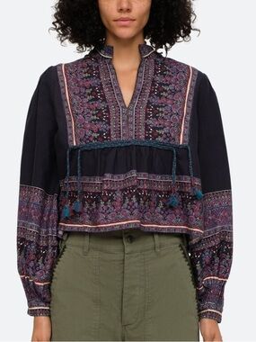 SEA - Adella border print top split v-neckline and braided tassel tie accents.